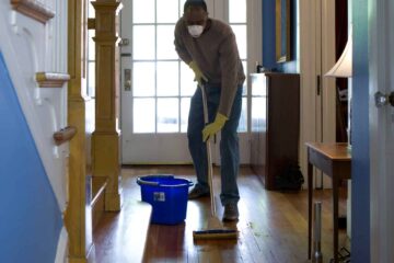 man mopping the hallway