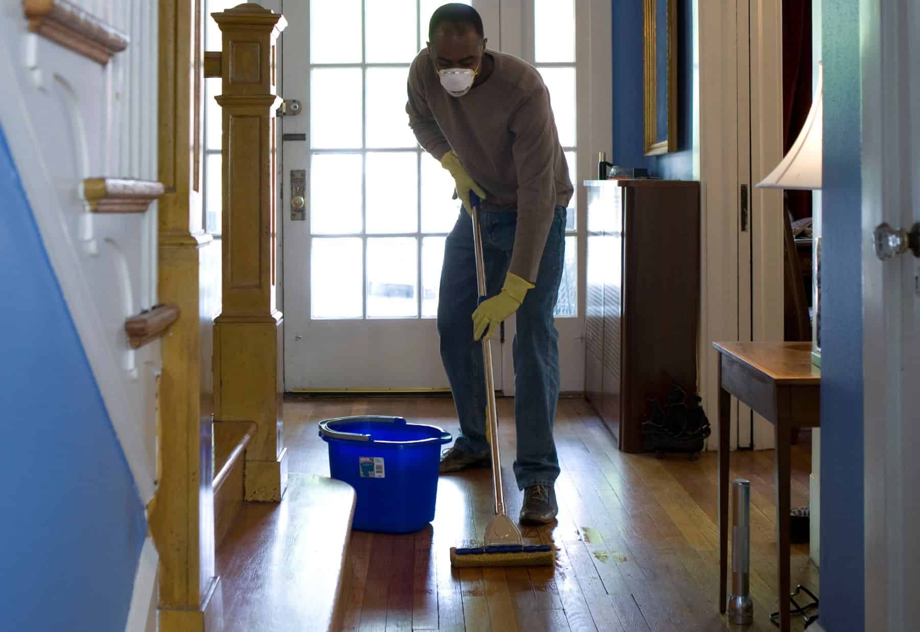 man mopping the hallway